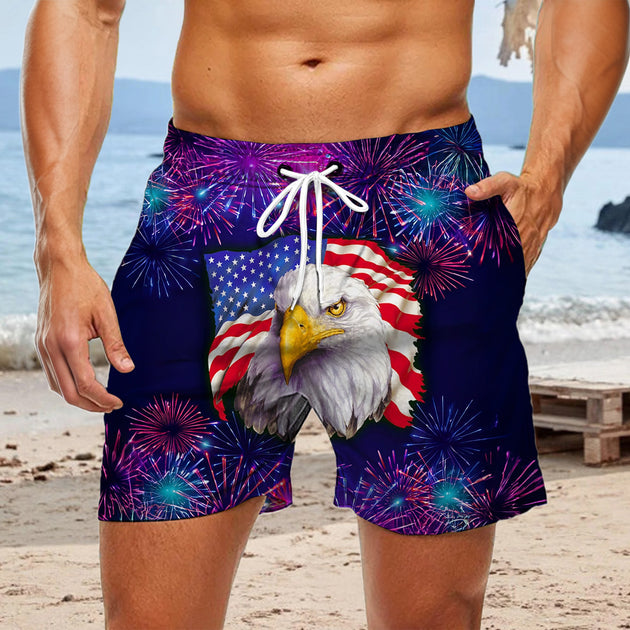 Men red white blue American flag print casual shorts at fireworks display for Independence Day lifestyle scene