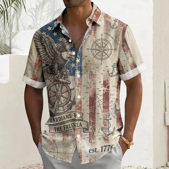 Men's American flag Hawaiian shirt lifestyle shot at beach, short sleeve tropical summer vacation outfit for Independence Day