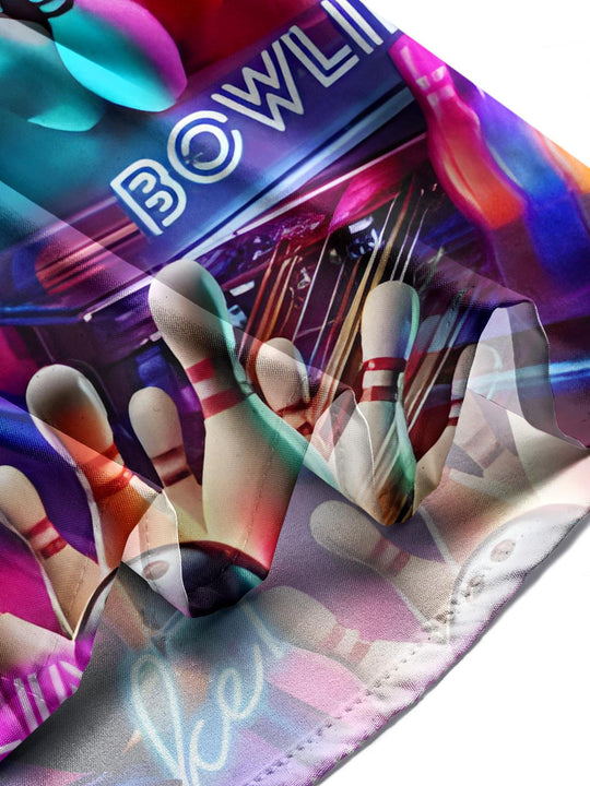 Man in bowling print short sleeve shirt at bowling alley