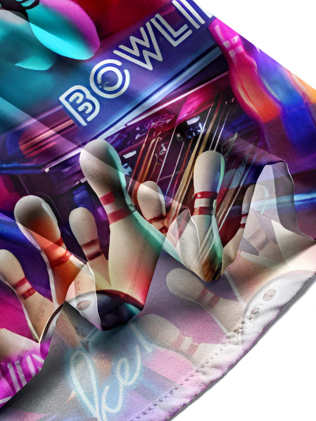 Man in bowling print short sleeve shirt at bowling alley