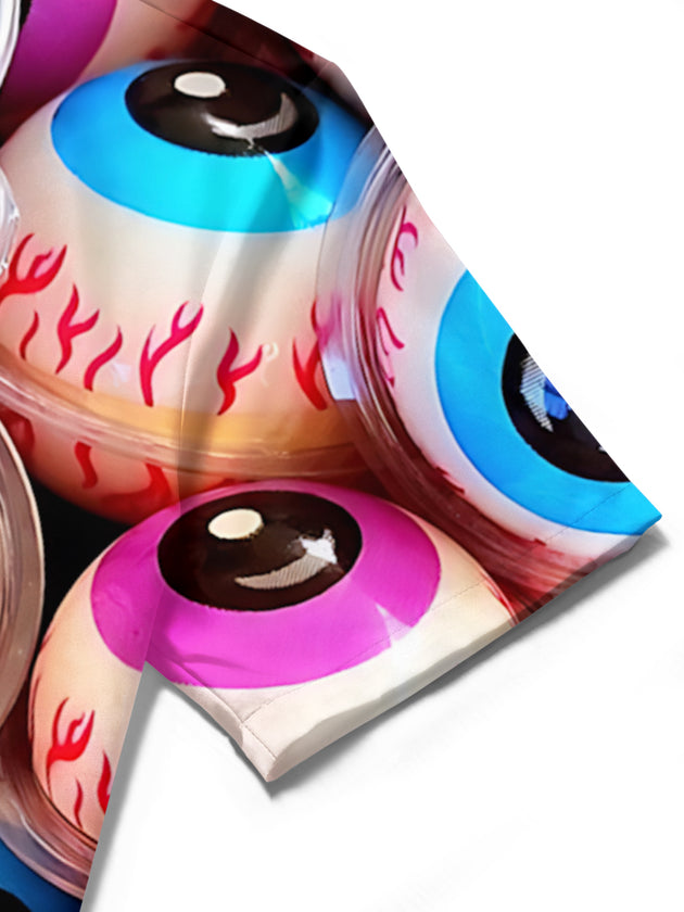 Men's Halloween eyeball candy print pocket short sleeve shirt detail close-up showing fabric texture and stitching